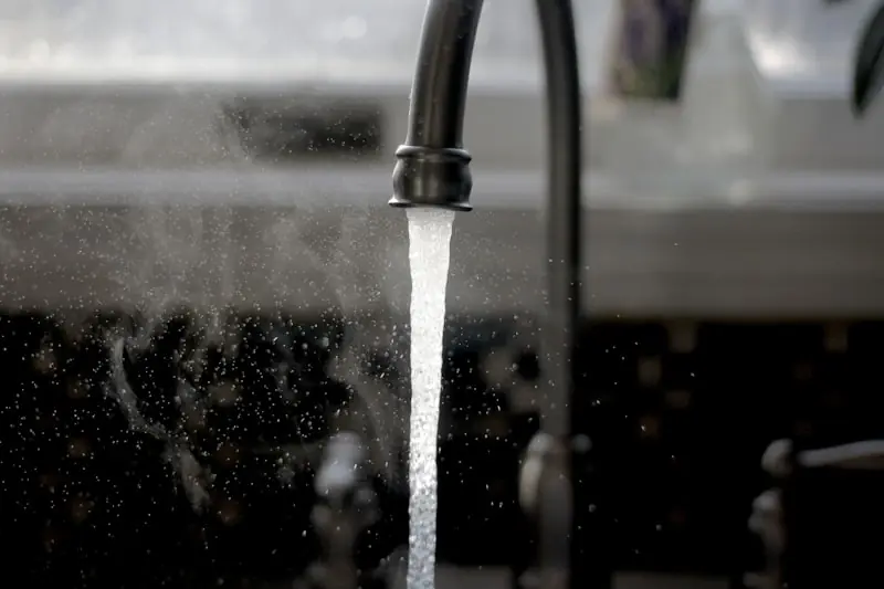 Water running from a kitchen tap.